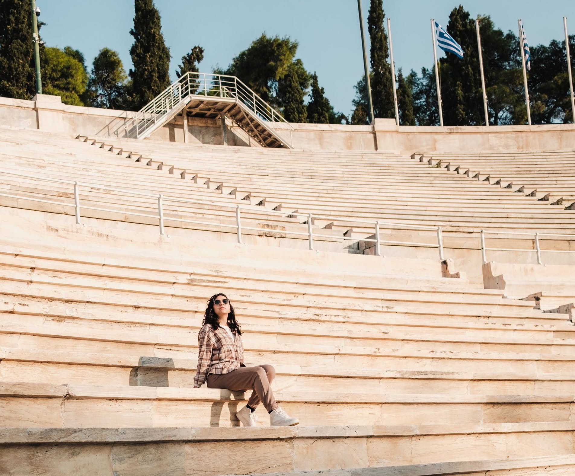 Athena's Journey Woman on Panathenaic Stadium ancient steps in Athens, Greece